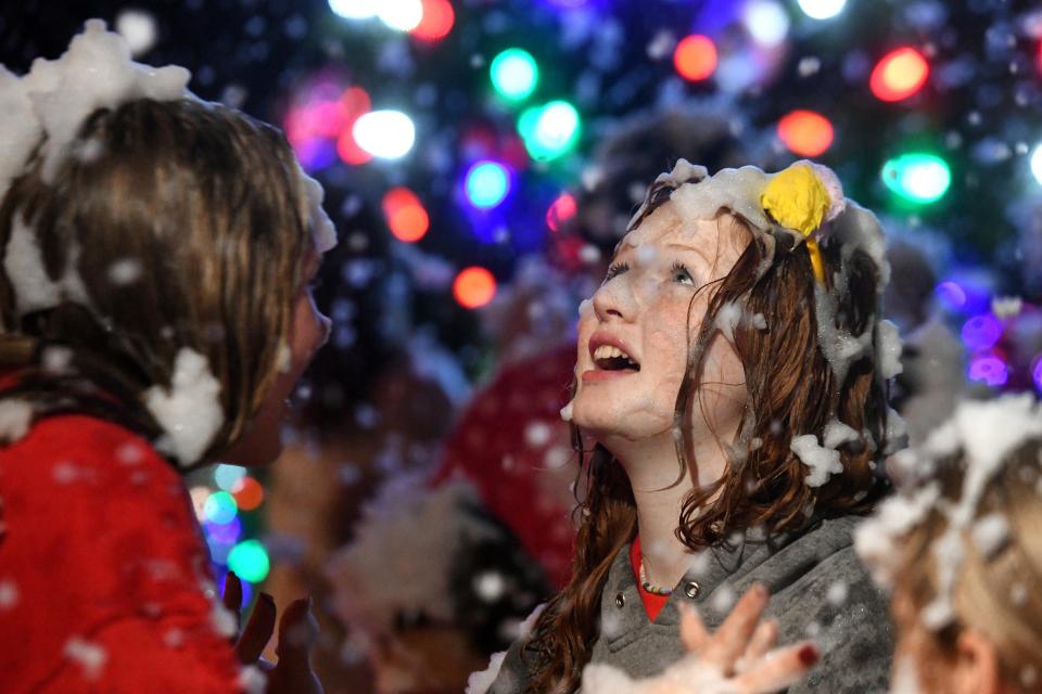 Mackenzie Goen, right, and Grace Sally, left, dance with others to holiday music during the Town of Shalimar's annual lighting of the Christmas tree celebration last year. This year's tree-lighting ceremony is scheduled for 5 p.m. Saturday, Dec. 10 at 2 Cherokee Road in Shalimar.