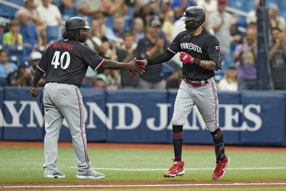 Minnesota Twins' Carlos Correa celebrates with third base coach Tommy Watkins (40) after his home run off Tampa Bay Rays' Yonny Chirinos during the fourth inning of a baseball game Thursday, June 8, 2023, in St. Petersburg, Fla. (AP Photo/Chris O'Meara)
