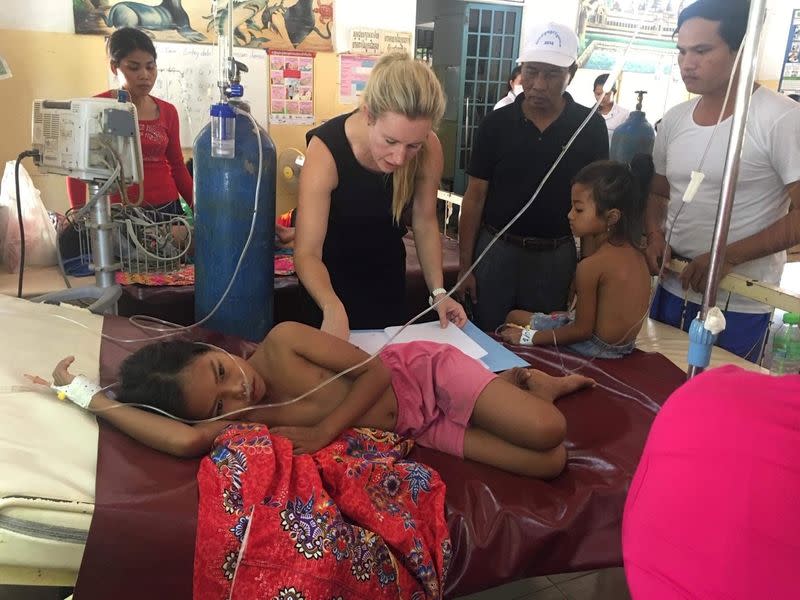 Jessica Manning cares for a sick girl at Kampong Speu District Referral Hospital in Krong Chbar Mon