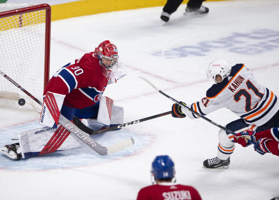 Edmonton Oilers' Dominik Kahun (21) scores the winning goal on Montreal Canadiens goaltender Cayden Primeau (30) during overtime in an NHL hockey game, Wednesday, May 12, 2021 in Montreal. (Ryan Remiorz/Canadian Press via AP)