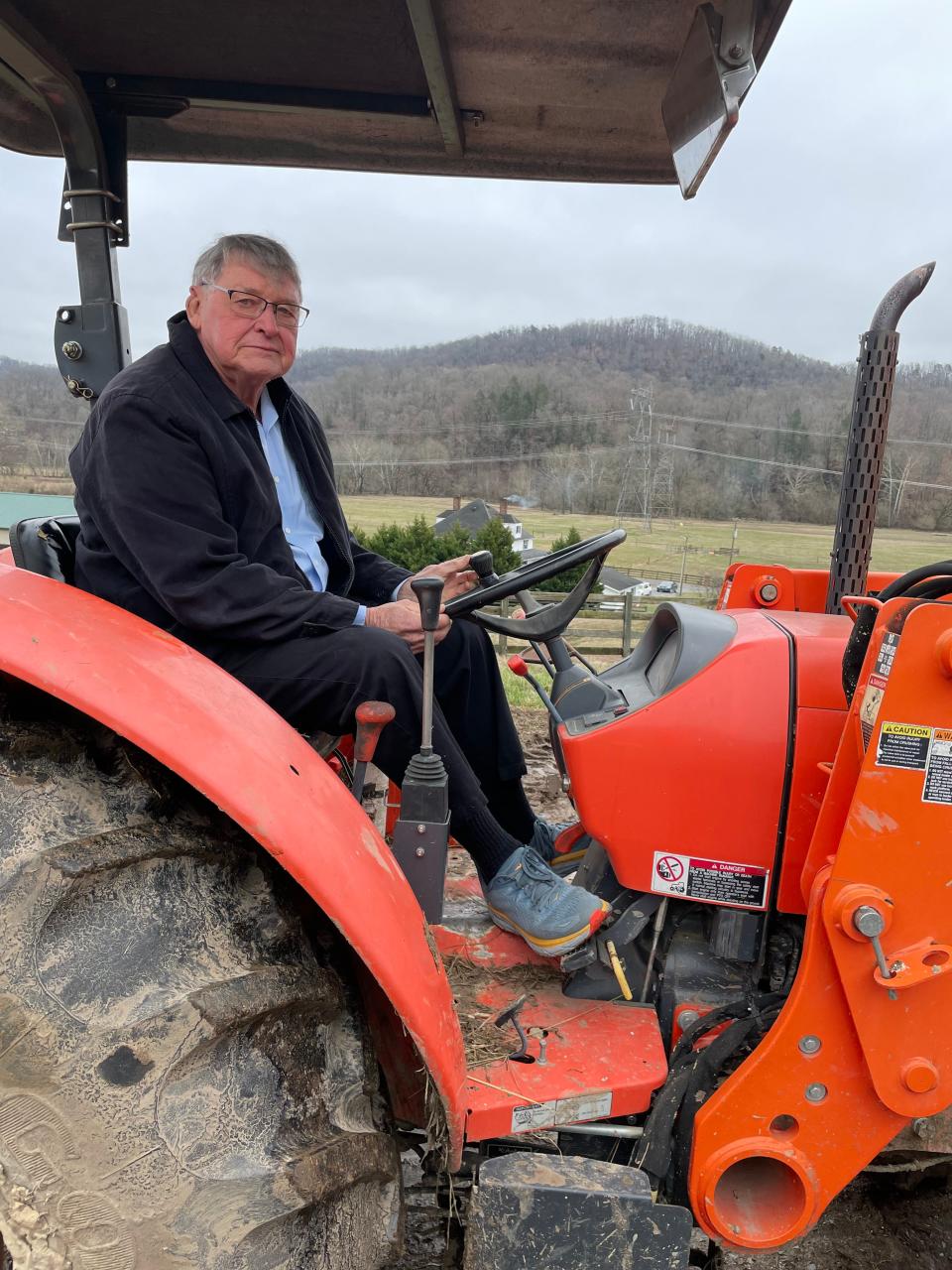 On his farm, Richard Neal enjoys getting around on his tractor.