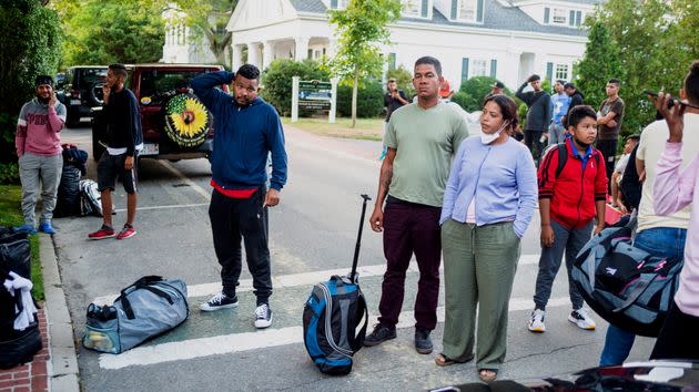 Migrants, who arrived on a flight sent by Florida Gov. Ron DeSantis, gather with their belongings outside St. Andrews Episcopal Church on Martha's Vineyard. (Photo: via Associated Press)