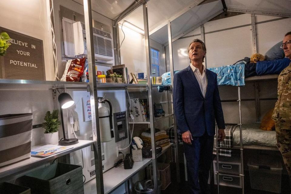 Gov. Gavin Newsom tours a tiny home Thursday after he announced that the state will have 1,200 tiny homes built and delivered throughout California in an effort to help house the homeless population.
