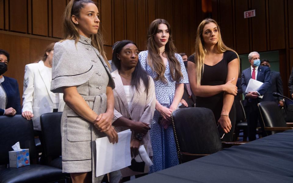 Olympic gymnast Aly Raisman, form left, Olympic gymnast Simone Biles, Olympic gymnast McKayla Maroney, and Collegiate gymnast Maggie Nichols leave following a Senate Judiciary Committee hearing - AFP