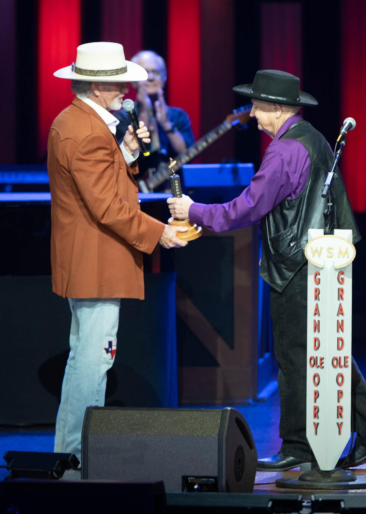 Larry Gatlin presenting Charlie McCoy with Opry member award