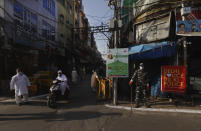 A para-military force soldier stands guard on Eid al-Fitr at the old quarters of New Delhi, India, Monday, May 25, 2020. The holiday of Eid al-Fitr, the end of the fasting month of Ramadan, a usually joyous three-day celebration has been significantly toned down as coronavirus cases soar. (AP Photo/Manish Swarup)