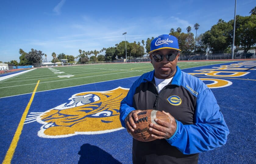 LOS ANGELES, CA - OCTOBER 20, 2021: Robert Garrett, head coach of the Crenshaw High School varsity football team, is photographed on the football field at the school. Crenshaw football team members have spent the week in quarantine, unable to practice, with this Friday's game against Locke High School looking unlikely. Last Friday, Crenshaw High School played a game against View Park Preparatory High School, a charter school authorized by L.A. Unified, that switched to remote learning for this week after enough students tested positive for the coronavirus to raise concerns. (Mel Melcon / Los Angeles Times)