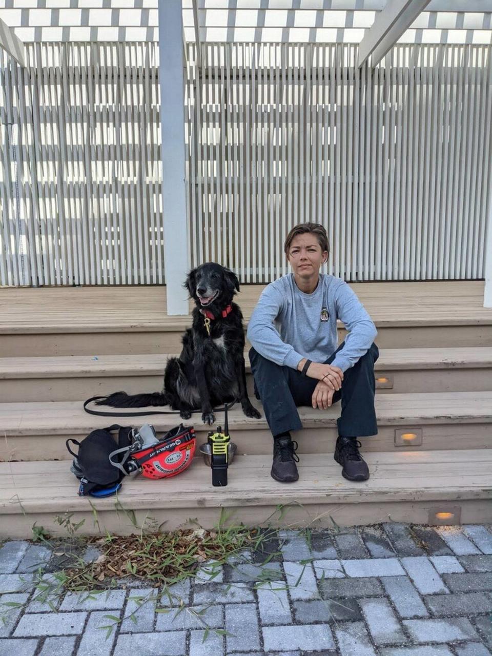 Nichole Notte, 40, rests with her dog, Dig, between search and rescue shifts at the Champlain Towers South condominium collapse.