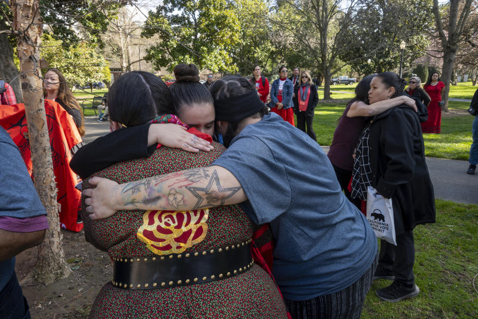 Tatum Starr, facing camera, is embraced by Sage Tellez-Ortiz, left and Wojapi Twobulls at the California State Capitol during the second annual Missing and Murdered Indigenous People Summit and Day of Action on Tuesday, Feb. 13, 2024, in Sacramento, Calif. (AP Photo/Jose Luis Villegas)