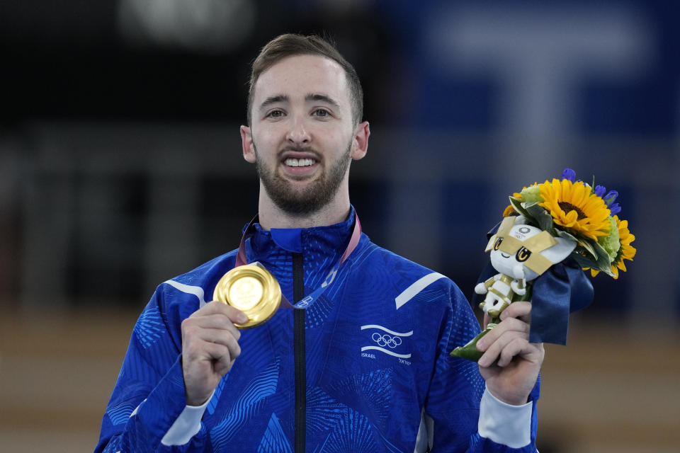 Artem Dolgopyat of Israel, poses after winning the gold medal after the floor exercise artistic gymnastics men's apparatus final at the 2020 Summer Olympics, Sunday, Aug. 1, 2021, in Tokyo, Japan. (AP Photo/Natacha Pisarenko)