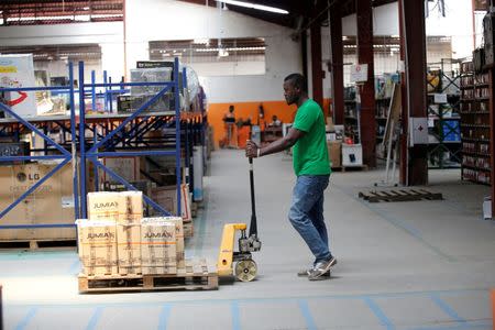 A man pushes a trolley cart through a warehouse for an online store, Jumia in Ikeja district, in Nigeria's commercial capital Lagos June 10, 2016. REUTERS/Akintunde Akinleye