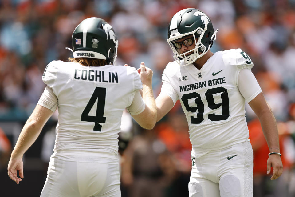 Michigan State place kicker Matt Coghlin (4) celebrates a made field goal with punter Bryce Baringer (99) during the second quarter of an NCAA college football game against Miami, Saturday, Sept. 18, 2021, in Miami Gardens, Fla. (AP Photo/Michael Reaves)