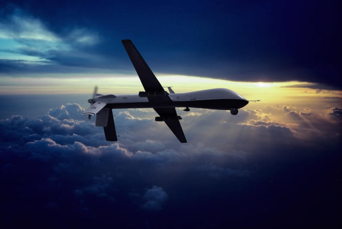 A military MQ-1 Predator unmanned drone with hellfire missiles flying at sunset. (Photo: Erik Simonsen via Getty)