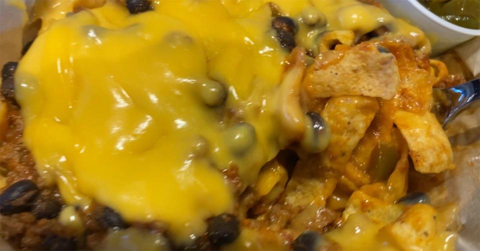 The Frito Chili Bowl at Eddy's features house-made chili, Fritos corn chips, and melted cheese.