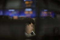A currency trader talks on the phone at a foreign exchange dealing room in Seoul, South Korea, Tuesday, April 11, 2023. Stocks were mostly higher in Asia on Tuesday after a mixed session on Wall Street dominated by speculation the Federal Reserve may tap the brakes again on financial markets and the economy by raising interest rates. (AP Photo/Lee Jin-man)