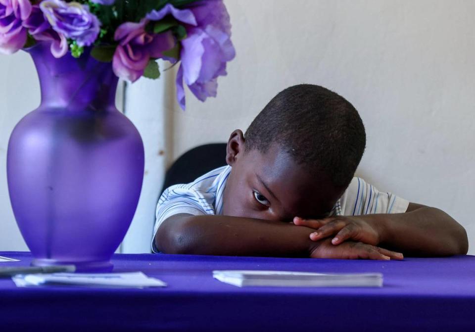 Germari Williams, 5, keeps a close eye on his grand aunt during service inside the St. John Institutional Missionary Baptist Church’s temporary location in its fellowship hall on Sunday, July 23, 2023, in Miami’s historic Overtown neighborhood.