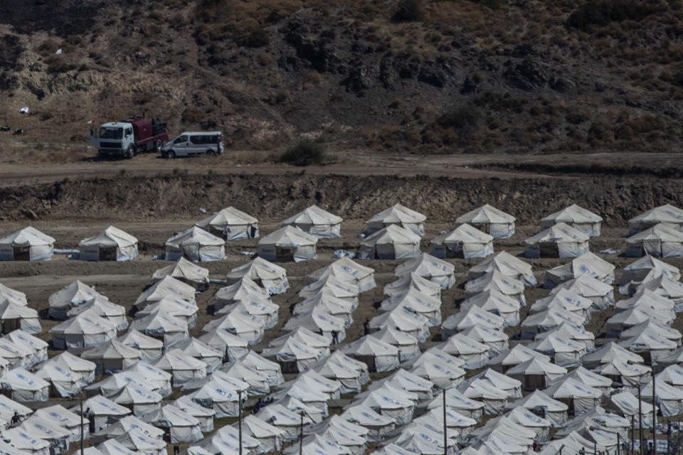 A general view of the temporary camp for refugees and migrants near Mytilene town, on the northeastern island of Lesbos, Greece, Sunday Sept. 13, 2020. Greek authorities have been scrambling to find a way to house more than 12,000 people left in need of emergency shelter on the island after the fires deliberately set on Tuesday and Wednesday night gutted the Moria refugee camp. (AP Photo/Petros Giannakouris)