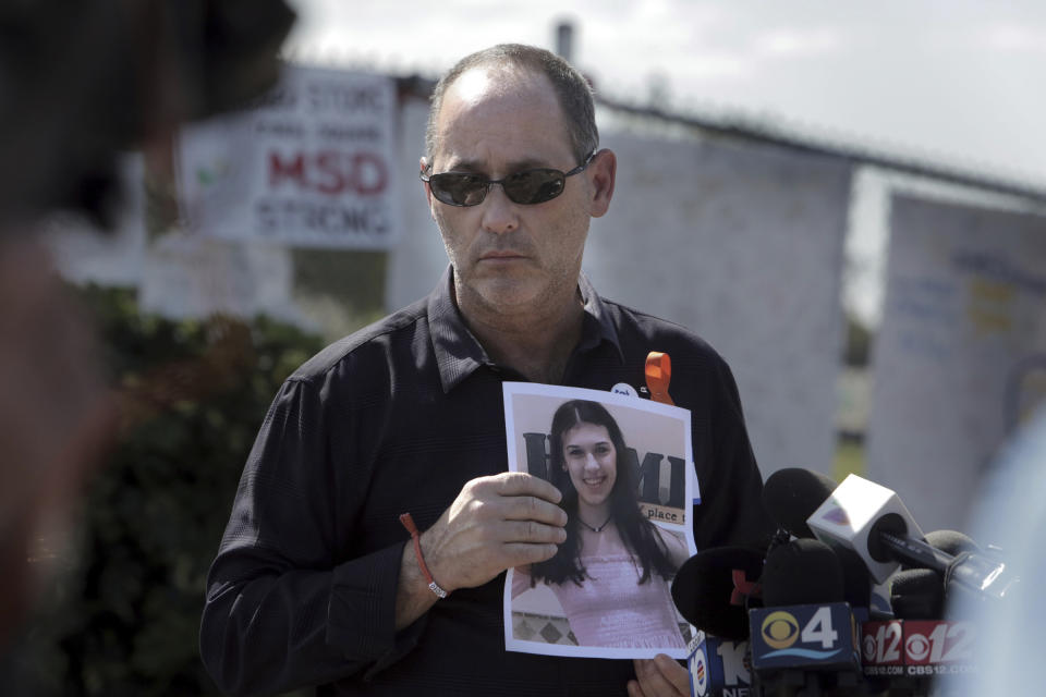 FILE - Fred Guttenberg, father of Jaime Guttenberg, holds a picture of his daughter, Monday, March 5, 2018, as he listens to questions from the media in front of Marjory Stoneman Douglas High School, in Parkland, Fla. (Jose A. Iglesias/Miami Herald via AP, File)