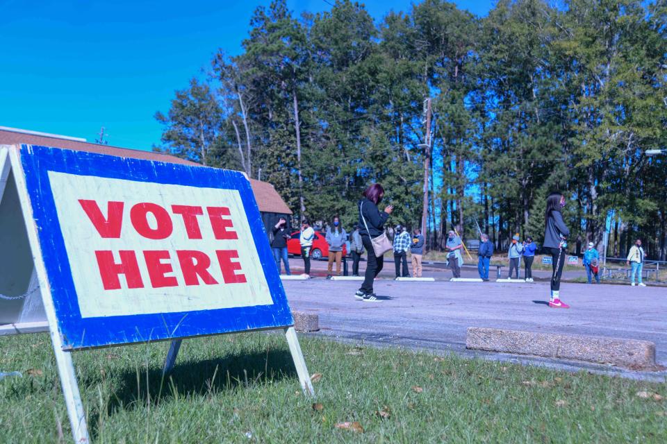 Dozens of voters line up around the outside of the Hub City Masonic Lodge, in Hattiesburg, MIss., Forrest County to cast their ballots on Election Day Tuesday, Nov. 3, 2020.