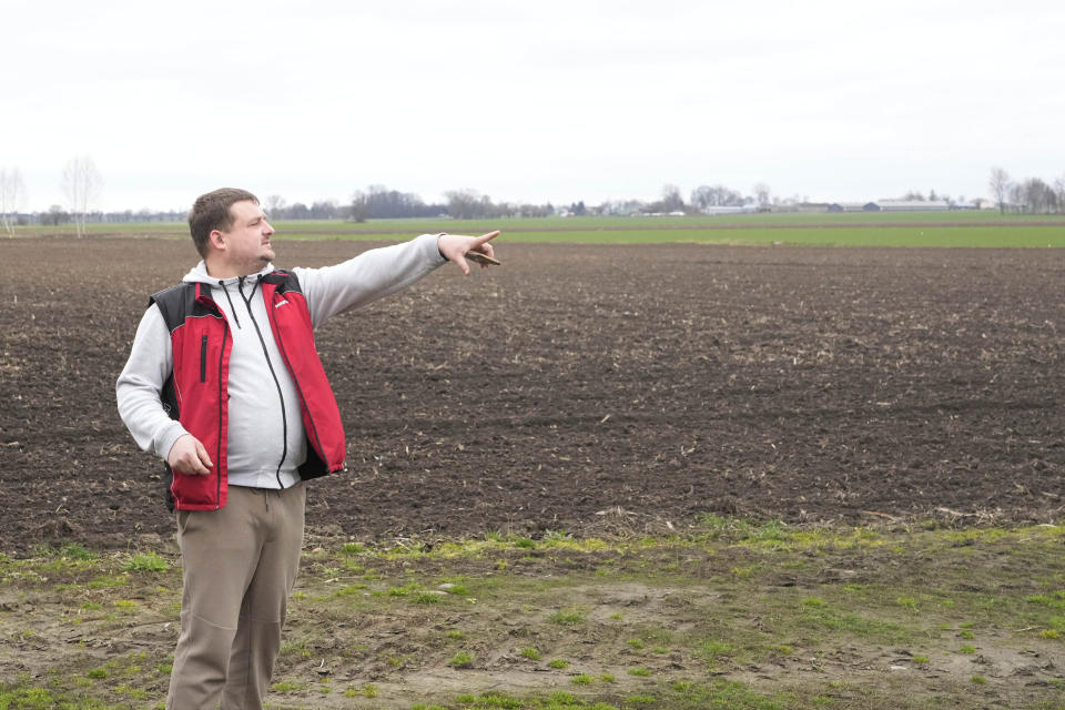 Piotr Korycki, a 34-year-old Polish farmer, points to fields on his farm in Cywiny Wojskie, Poland, on Monday March 18, 2024. Piotr says his business has been badly destabilized by Russia’s war against Ukraine and that the European Union is only adding to his problems. He's among the large number of farmers who have protested across Europe for months, and he’s organizing the latest protest planned for Poland on Wednesday. (AP Photo/Czarek Sokolowski)