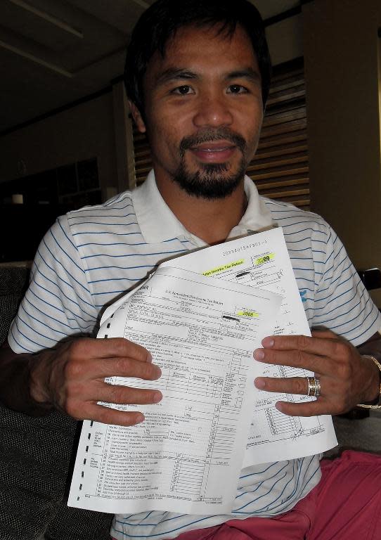 Manny Pacquiao shows a copy of 2008 and 2009 tax returns filed with the IRS in the US, during a meeting with journalists in General Santos City, on November 27, 2013