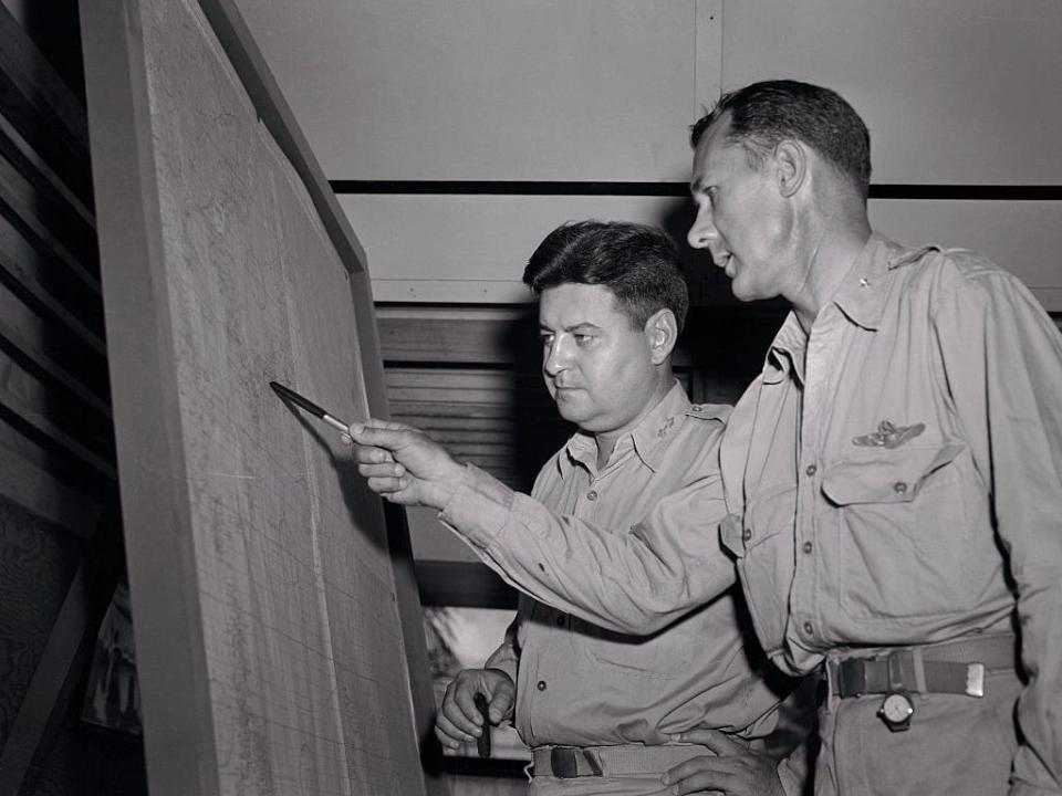 Major General Curtis E. LeMay (L) Commanding General, points out a detail on the map to his Chief of Staff, Brig. General A. W. Kissner, of Washington, D. C., as the two formulated plans for the next strike on the Japanese homeland by Marianas-Based Superforts.