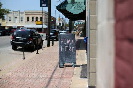 FILE PHOTO: A chalkboard pointing to a FEMA office is shown in the aftermath of tropical storm Harvey in Wharton, Texas, U.S., September 6, 2017. REUTERS/Mike Blake/File Photo