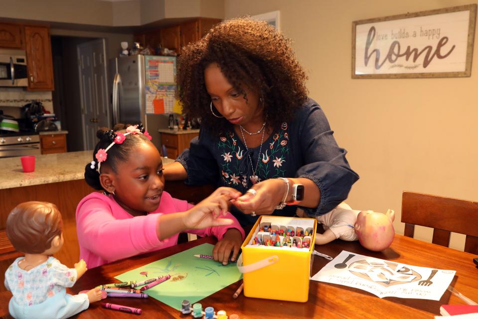 Trudy Kent watches her daughter Ariel, 6, draw at home in Tomkins Cove Nov. 16, 2020 while her other children are at school. Trudy and Warren Kent fostered six children and are now parents to three they have adopted. 