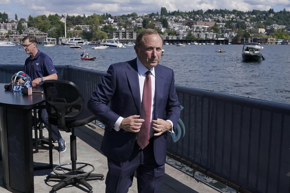 NHL Commissioner Gary Bettman walks next to Lake Union after taking part in an interview Wednesday, July 21, 2021, during the Seattle Kraken's expansion draft event in Seattle. (AP Photo/Ted S. Warren)