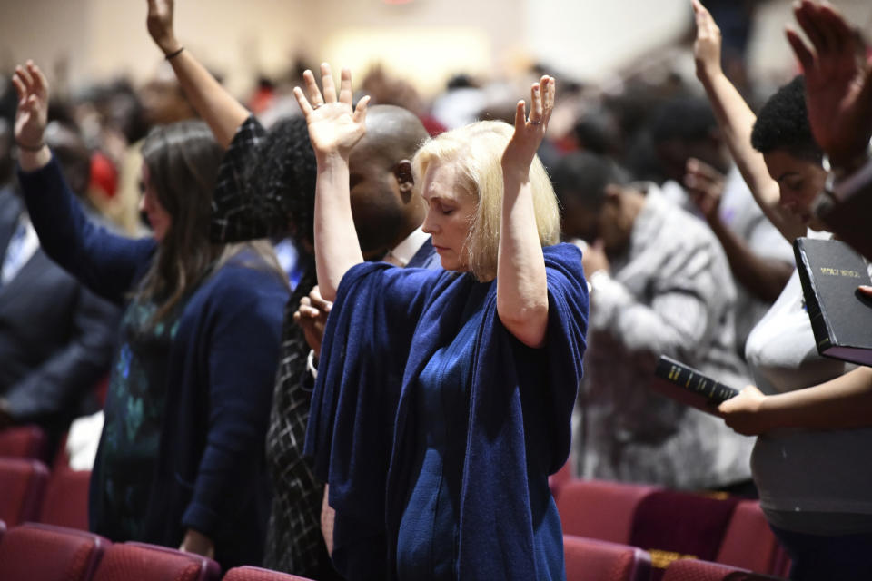 FILE - In this Feb. 10, 2019, file photo, Sen. Kirsten Gillibrand, D-N.Y., worships at Mount Moriah Missionary Baptist Church in North Charleston, S.C. By now, most Democratic presidential candidates have polished their stump speeches. But when they’re in South Carolina, they may need to add in a sermon. In a large and diverse primary field, White House hopefuls are angling to develop relationships with black churches. (AP Photo/Meg Kinnard, File)