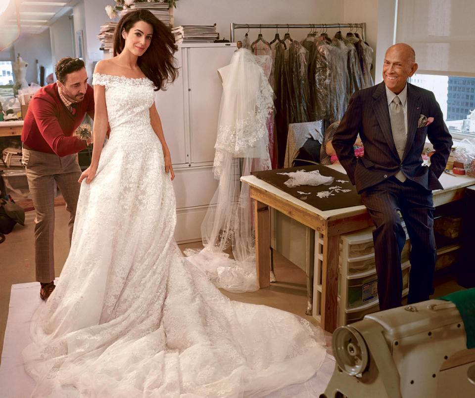 “George and I wanted a wedding that was romantic and elegant, and I can’t imagine anyone more able than Oscar to capture this mood in a dress,” George Clooney’s bride told Vogue in an exclusive interview. “Meeting him made the design process all the more magical, as he is so warm and such a gentleman.” De la Renta, pictured here during the final fitting with Alamuddin in his showroom, hand embroidered the ivory tulle bodice with beading and crystals, and used fourteen yards of Chantilly lace.