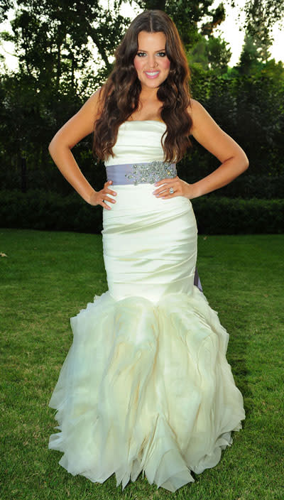 Khole Kardashian Odom: September 2009: Kim’s younger sister Khloe wore an ivory strapless Vera Wang gown with a mermaid tail. Khloe emphasised her slim waist with a purple jewelled sash for her wedding to basketball star Lamar Odom. Photo Rex