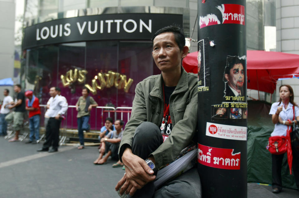 CORRECTS YEAR PHOTO WAS TAKEN IN TO 2010 INSTEAD OF 2011 - In this photo taken May 12, 2010, red shirt protesters listen to a speech during a rally at Ratchaprasong intersection in Bangkok, Thailand. The protest was dispersed by then deputy prime minister Suthep Thaugsuban who later ordered a crackdown that saw the army rip through the protesters' tire-and-bamboo-barricaded encampments and fire M-16s into crowds of fleeing protesters. Today, Suthep is leading a protest movement that has itself blocked roads and broken into government offices - an extraordinary role reversal that underscores not only the cyclical nature of Thai politics, but the total lack of progress toward bridging a political divide that has plagued the country for nearly a decade. (AP Photo/Apichart Weerawong)