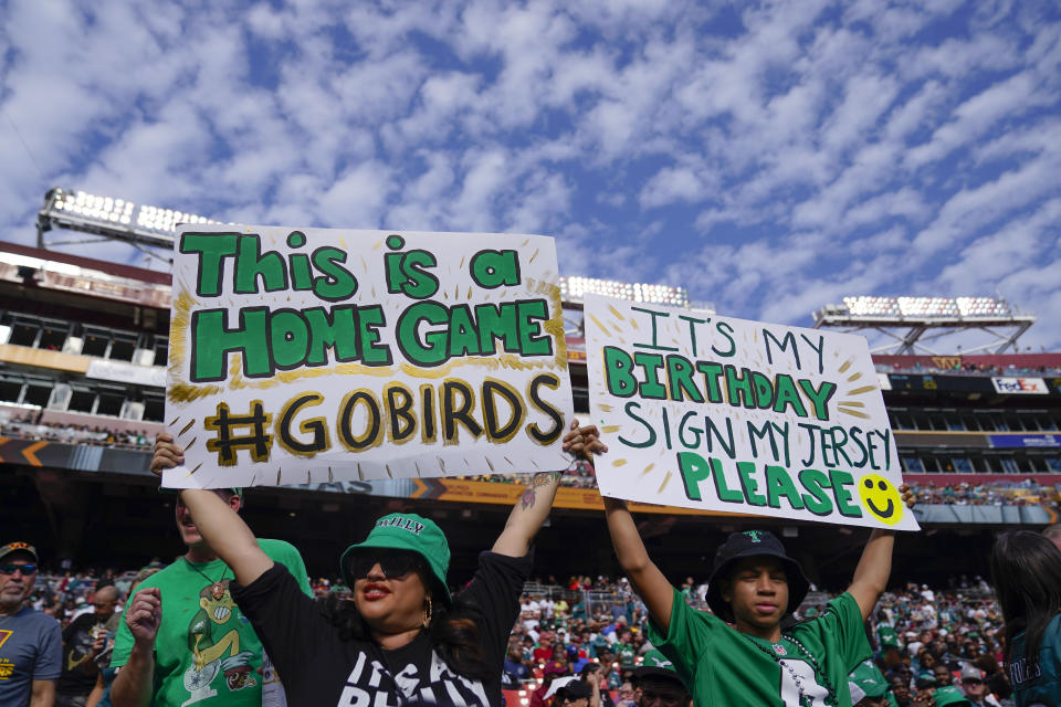 Philadelphia Eagles fams holding up signs during the second half of an NFL football game against the Washington Commanders, Sunday, Oct. 29, 2023, in Landover, Md. (AP Photo/Alex Brandon)