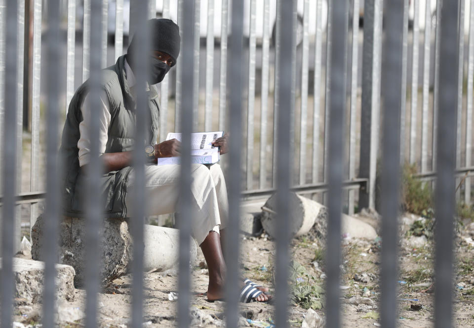 A man wearing a face mask is seen at a refugee camp in Bellville, a suburb of Cape Town, South Africa, Thursday, May 21, 2020. With dramatically increased community transmissions, Cape Town has become the centre of the coronavirus outbreak in South Africa and the entire continent. (AP Photo/Nardus Engelbrecht)