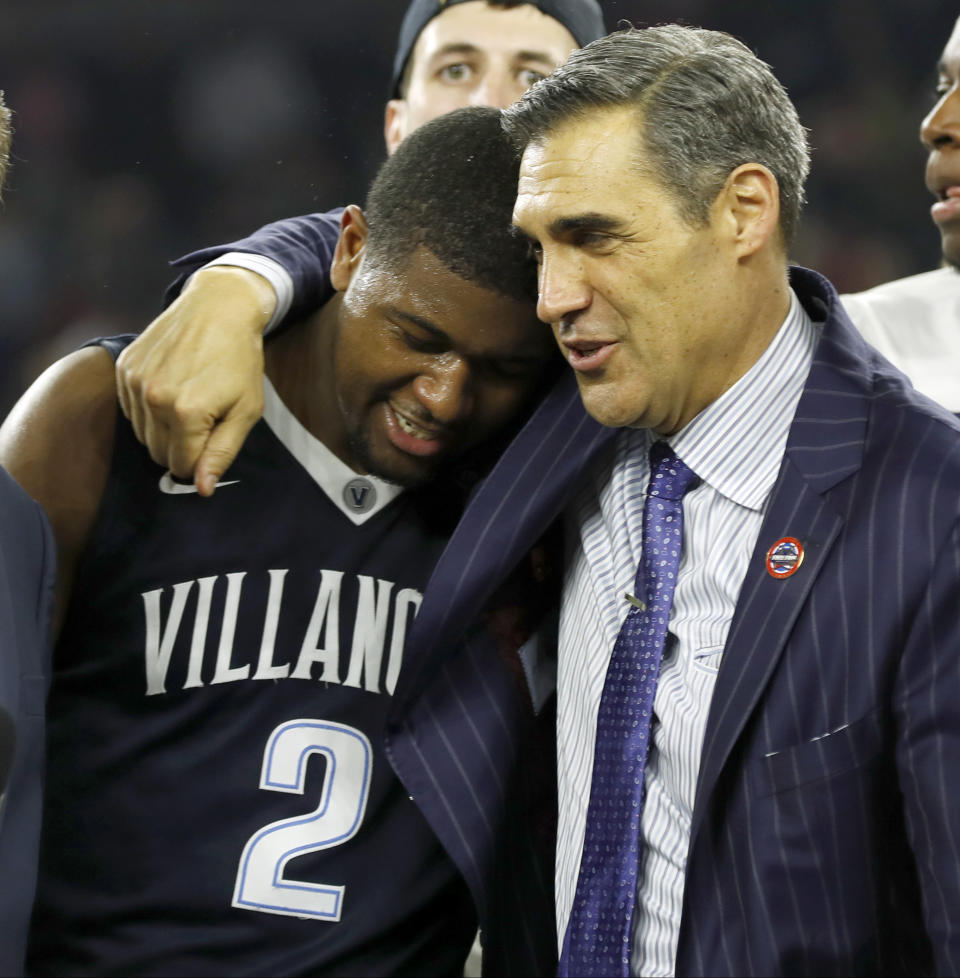 FILE - In this April 4, 2016, file photo, Villanova head coach Jay Wright, right, embraces Kris Jenkins after Jenkins scored the game-winning three-point basket in the closing seconds of the NCAA Final Four college basketball championship game against North Carolina, in Houston. (AP Photo/David J. Phillip, File)