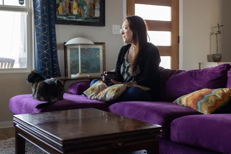 Jolene and her cat look outside the window of their home in Hutto on Mar. 2, 2024. Jolene was drinking a coffee that she brewed that morning.