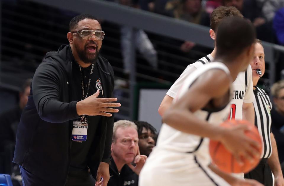 Buchtel boys basketball coach Rayshon Dent calls plays from the sideline during the first half of the OHSAA Division II state championship game against Lutheran West at UD Arena on March 19 in Dayton.