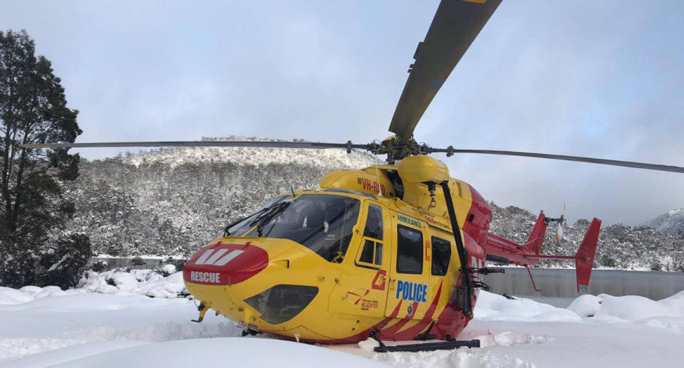 Photo of the Westpac Rescue helicopter sinking into the snow during a Tasmanian search mission.