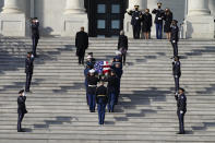 A joint services military bearer team moves the casket of former Sen. Bob Dole, R-Kan., during arrival at the U.S. Capitol, where he will lie in state in the Rotunda, Thursday Dec. 9, 2021, on Capitol Hill in Washington, as Elizabeth Dole and daughter Robin watch at top right. (AP Photo/Jacquelyn Martin)