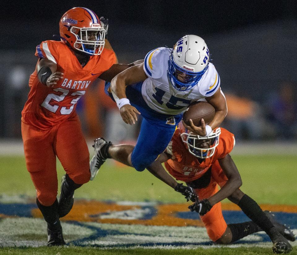 Auburndale (15) Robbie Gaskin is tripped up by Bartow defenders in first-half action at Bartow High School in Bartow on Sept. 23.