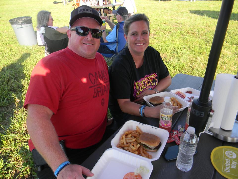 Adam and Keri Daugherty enjoy burgers and fries at the inaugural Oak Ridge Food Truck Rally.