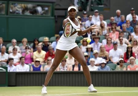 Venus Williams of the U.S.A. hits a shot during her match against Serena Williams of the U.S.A. at the Wimbledon Tennis Championships in London, July 6, 2015. REUTERS/Toby Melville