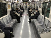 Passengers wearing face masks ride a subway train in Daegu, South Korea, Friday, Feb. 21, 2020. South Korea on Friday declared a "special management zone" around a southeastern city where a surging viral outbreak, largely linked to a church in Daegu, threatens to overwhelm the region's health system. (Kim Hyun-tae/Yonhap via AP)