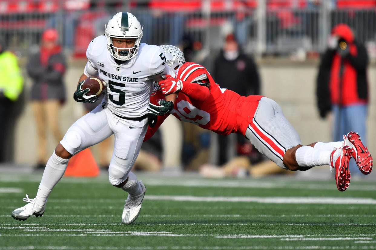 COLUMBUS, OH - NOVEMBER 11:  Hunter Rison #5 of the Michigan State Spartans shakes off the  tackle from Malik Harrison #39 of the Ohio State Buckeyes in the fourth quarter to pick up yardage at Ohio Stadium on November 11, 2017 in Columbus, Ohio. Ohio State defeated Michigan State 48-3.  (Photo by Jamie Sabau/Getty Images)