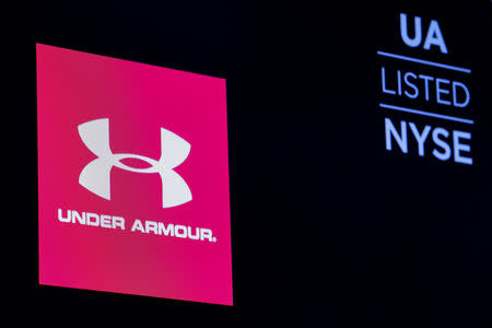 FILE PHOTO: The ticker symbol and company logo for Under Armour, Inc. is displayed on a screen on the floor of the New York Stock Exchange (NYSE) in New York, U.S., January 22, 2019. REUTERS/Brendan McDermid/File Photo