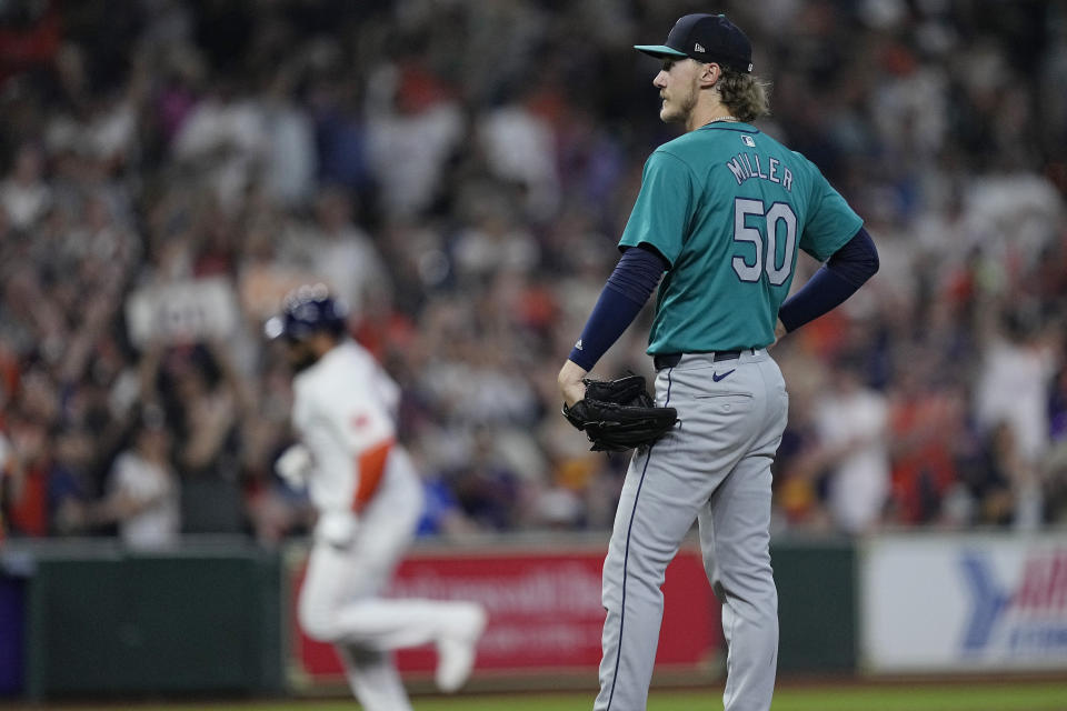 Seattle Mariners starting pitcher Bryce Miller waits for Houston Astros' Jon Singleton to run the bases after hitting a go-ahead two-run home run during the seventh inning of a baseball game, Sunday, May 5, 2024, in Houston. (AP Photo/Kevin M. Cox)