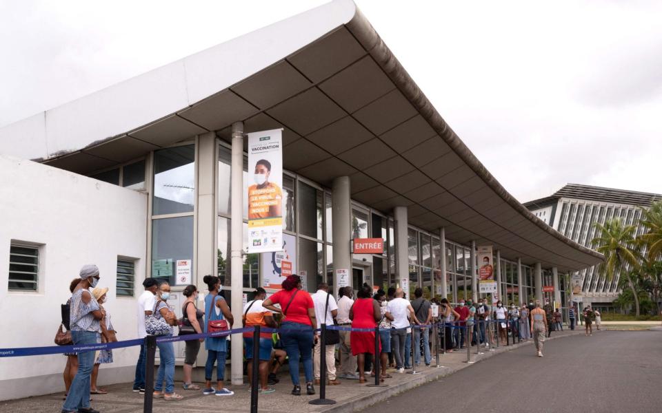 People wait in line to be vaccinated in Pointe-a-Pitre, on the French Caribbean archipelago of Guadeloupe - AFP