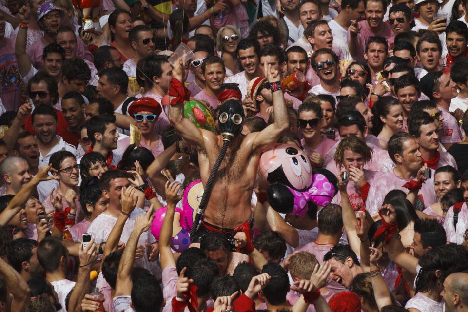 Revelers take part on the 'Chupinazo', the official opening of the 2012 San Fermin fiestas, Friday, July 6, 2012 in Pamplona, Spain. Can we expect on Syrian Brig. Gen. Manaf Tlass had abandoned Assad's regime(AP Photo/Daniel Ochoa de Olza)