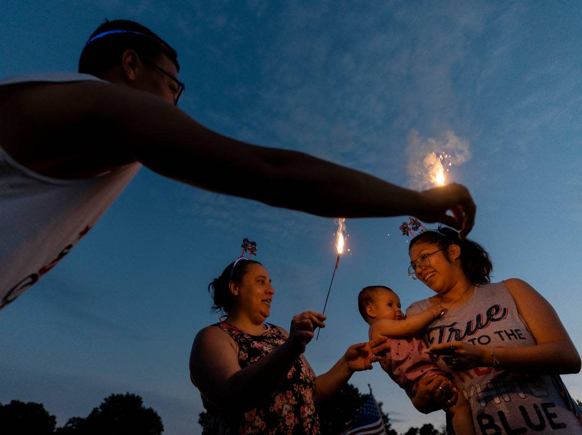 People light sparklers during an Independence Day celebration at Dorothea Dix Park on Tuesday, July 4, 2023, in Raleigh, N.C. Kaitlin McKeown/kmckeown@newsobserver.com